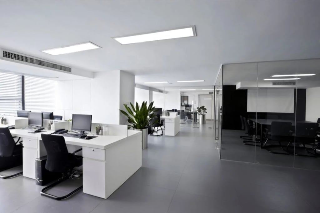 Modern Office Workspace Setting Modern open-plan office workspace with white desks, black chairs, computer monitors, and a glass-walled conference room reminiscent of settings from workplace comedy TV shows like The Office