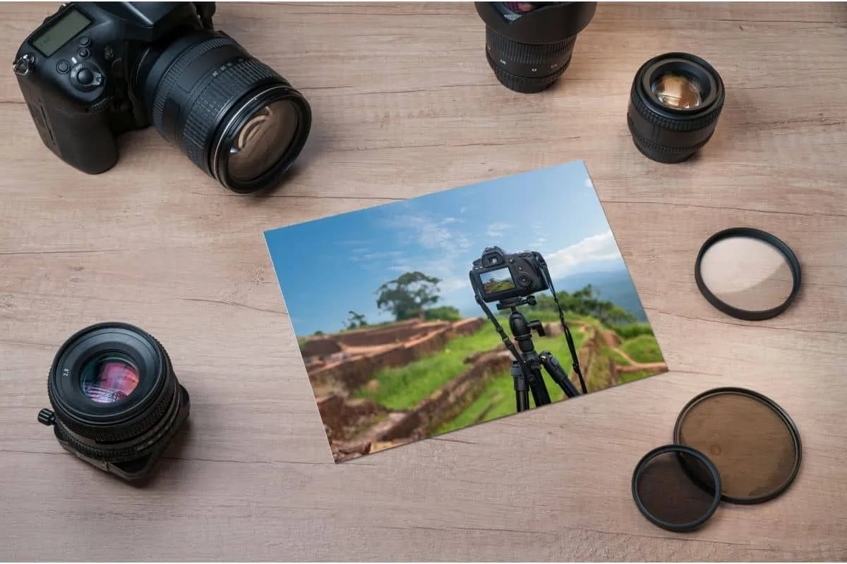 High-quality professional DSLR camera with various lenses and filters arranged on wooden surface illustrating movies about photography