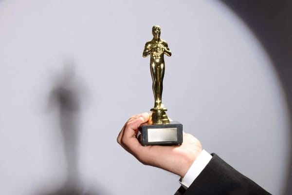 Leonardo DiCaprio holding the golden Oscar statuette symbolizing his Academy Award victory in the film industry