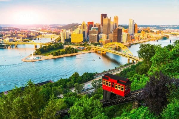 Pittsburgh city skyline and river viewed from lush hill with historic funicular, popular location for movies filmed in Pittsburgh