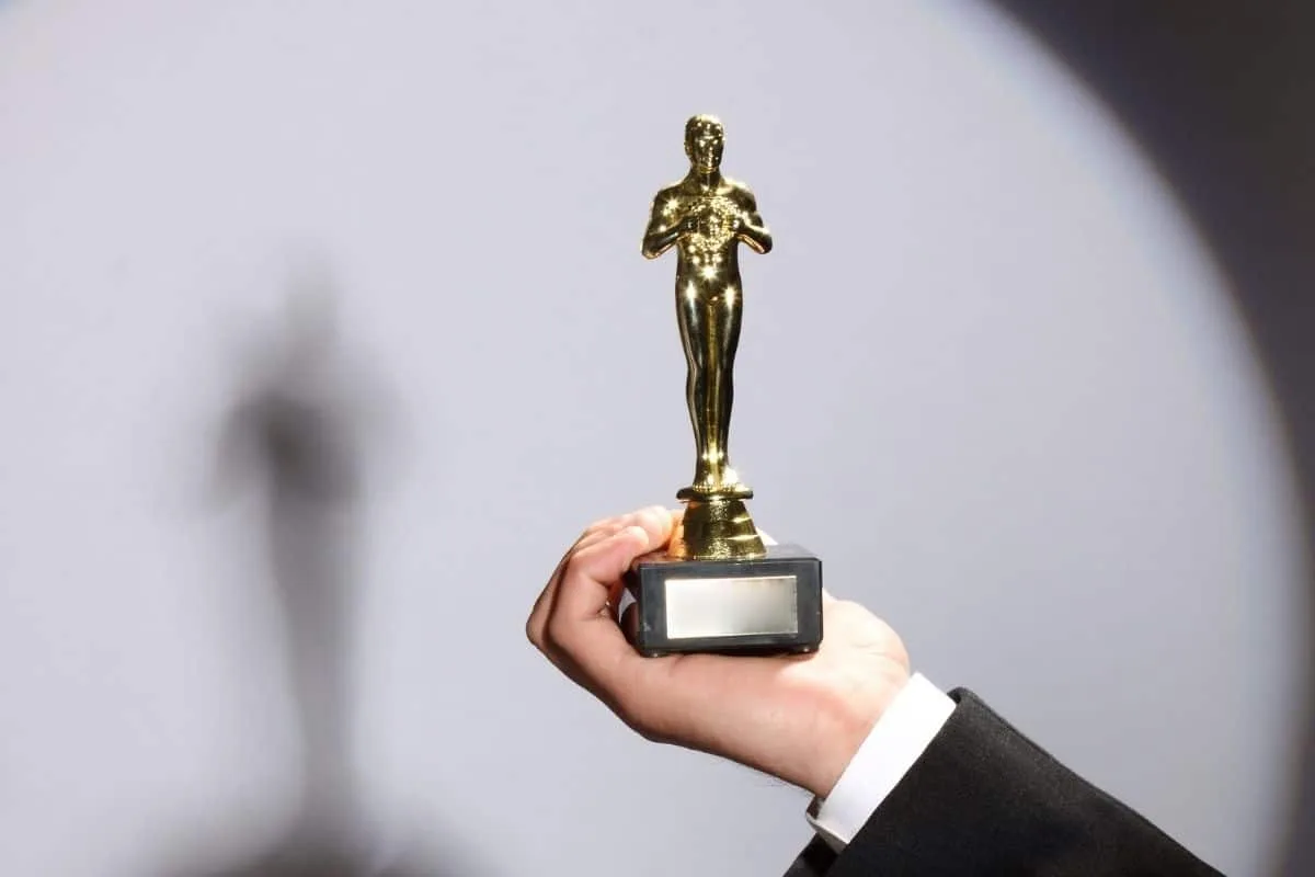 Golden award trophy held in hand, symbolizing excellence in TV Hulk content or achievement.