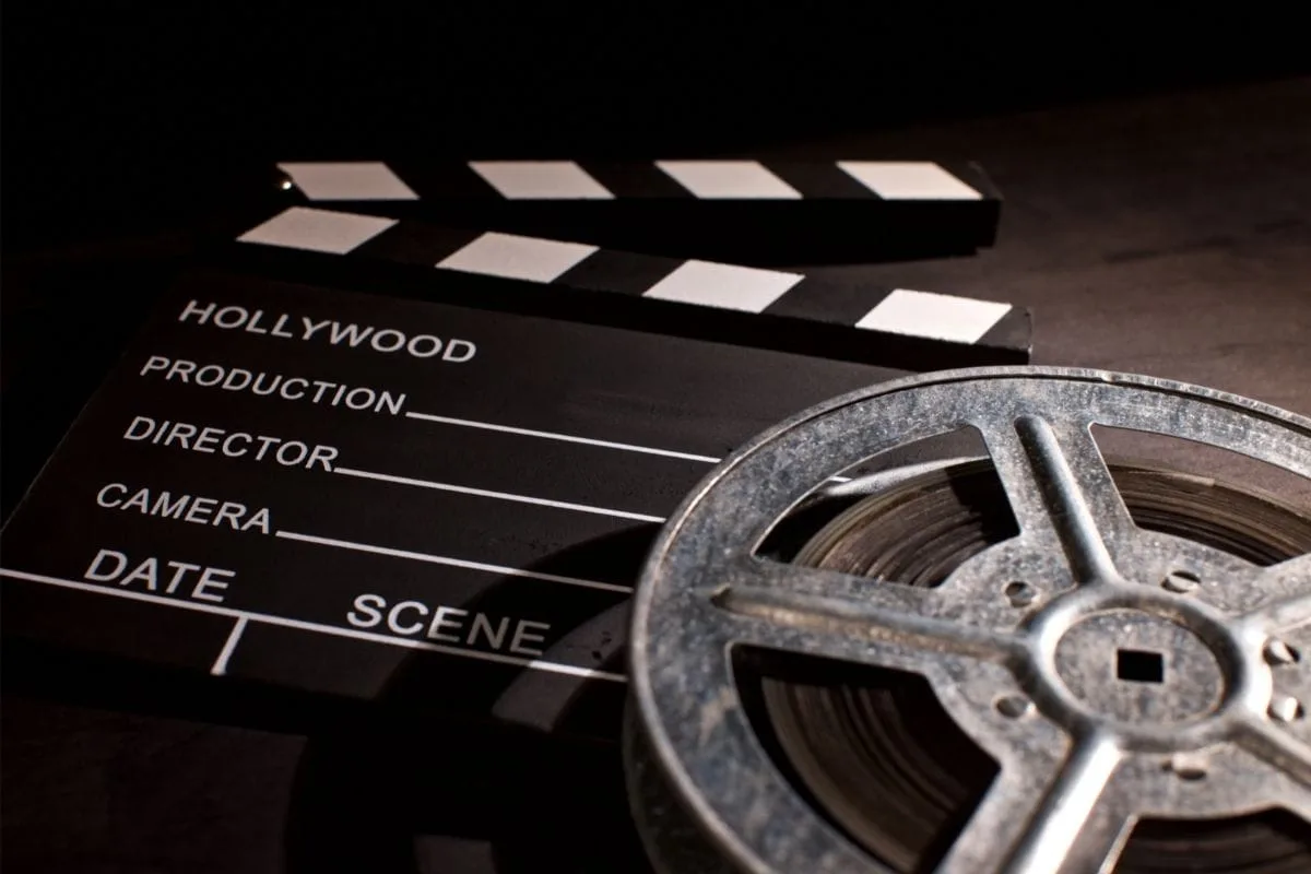 Cinema equipment, film reel, clapperboard, Hollywood film production, movie set tools.
