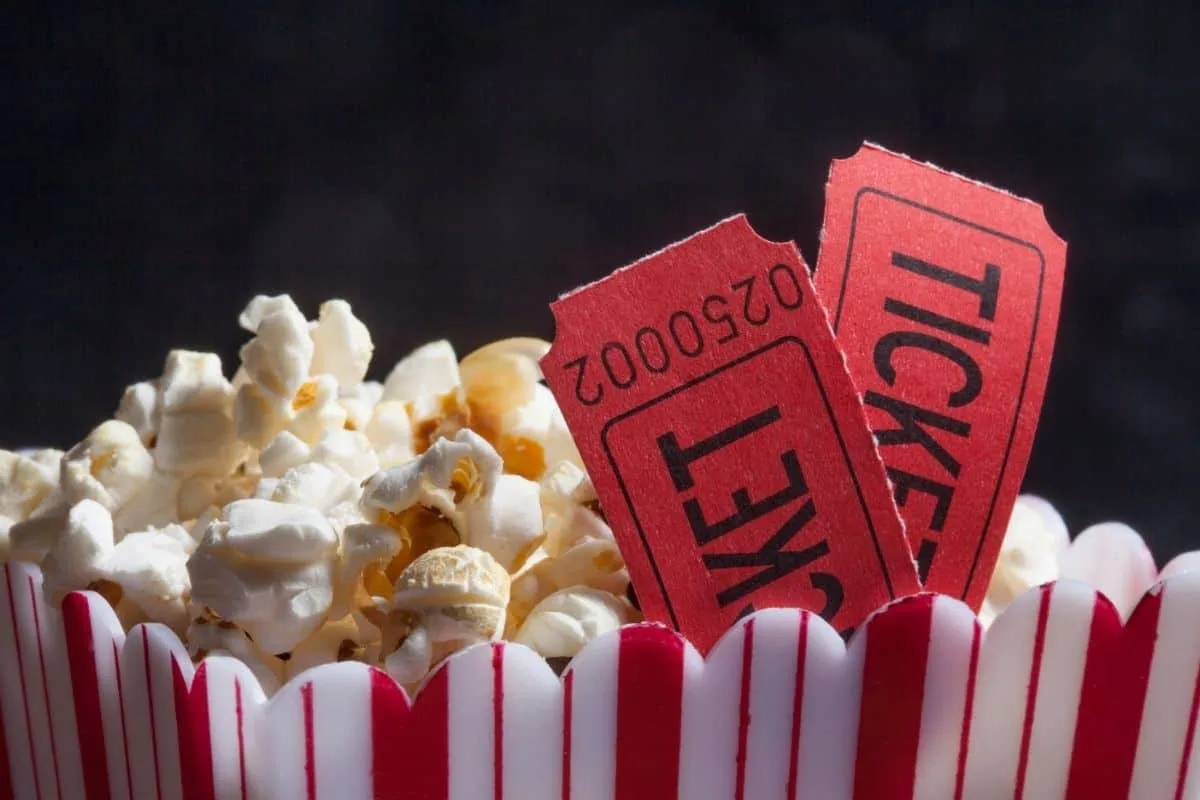 Popcorn with movie tickets for a fun cinema experience.