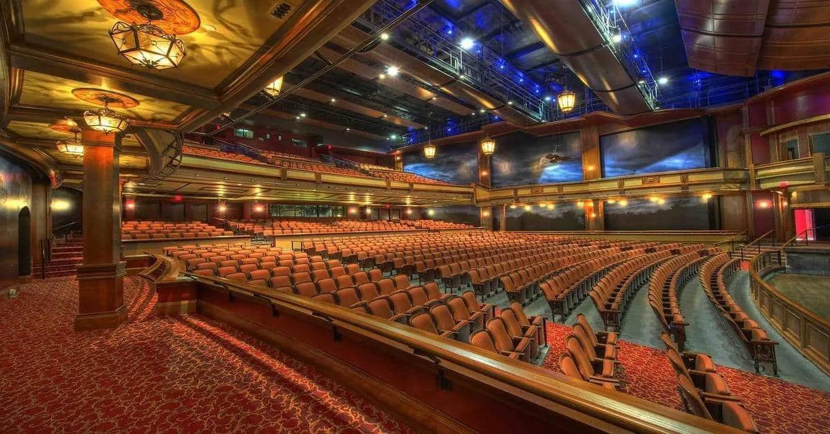 Elegant theater with plush seating, ornate decor, and advanced lighting for live performances.