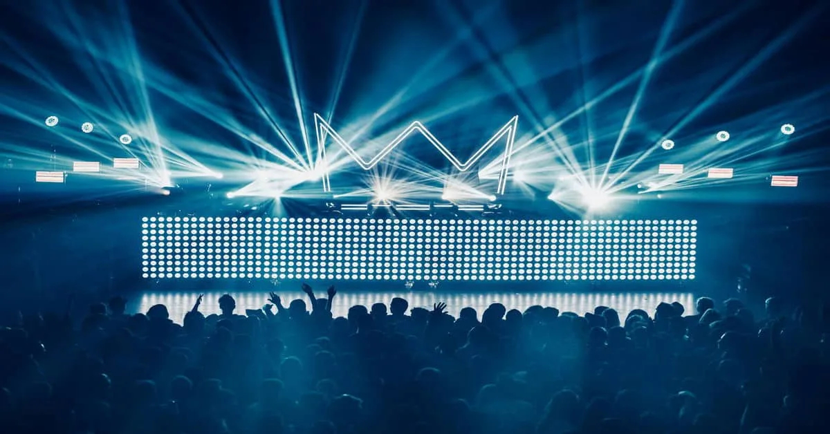 Vivid LED stage lighting at a concert with bright spotlights creating an energetic atmosphere.