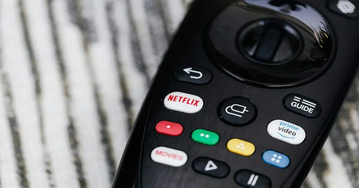 Remote control featuring Netflix, Prime Video, and streaming app buttons for seamless digital TV streaming.