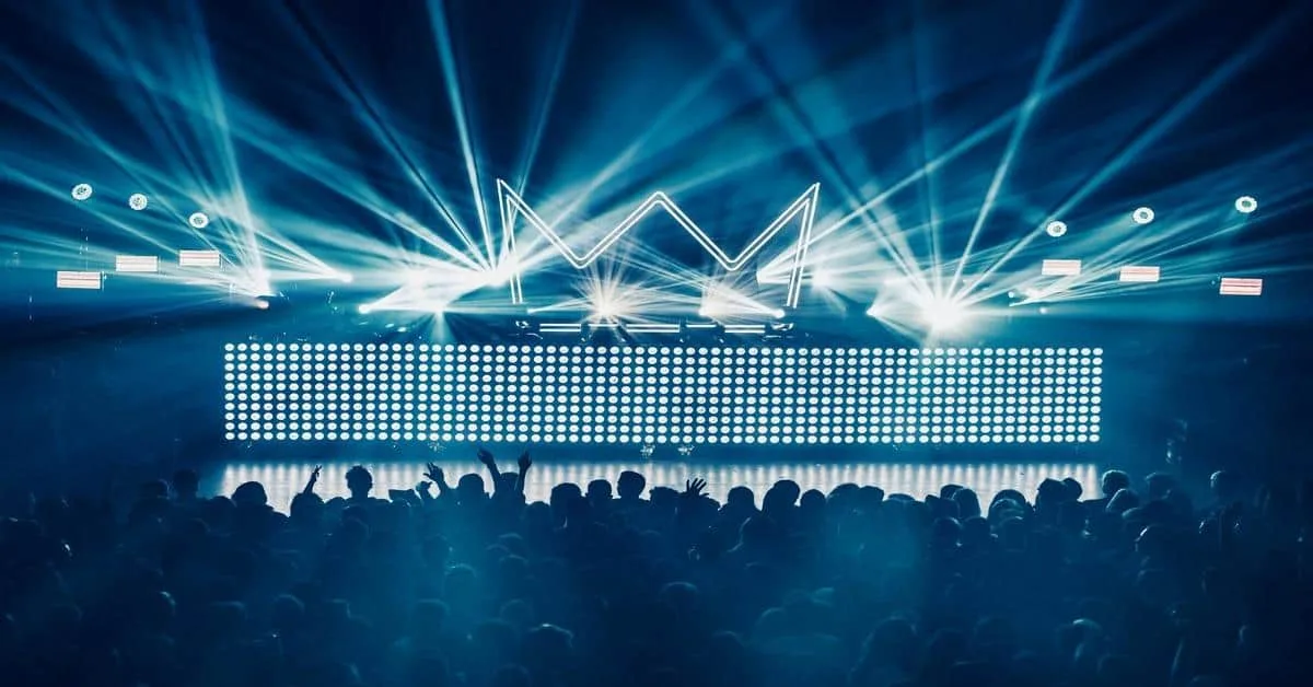 Vibrant stage with dynamic lighting and LED screen at a music event.