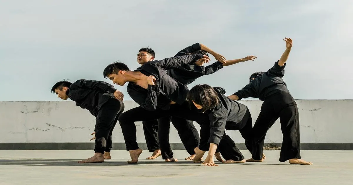 High-energy martial arts team practicing disciplined techniques on the roof top during sunset.