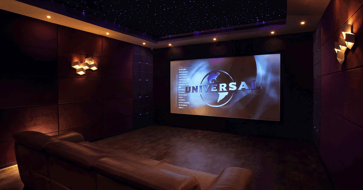 Luxurious private home theater with large projector screen and comfortable seating.