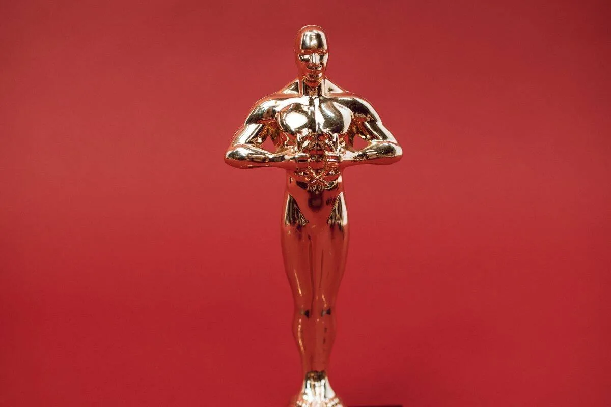 Leonardo DiCaprio holding his Oscar statuette celebrating his Academy Award win for Best Actor