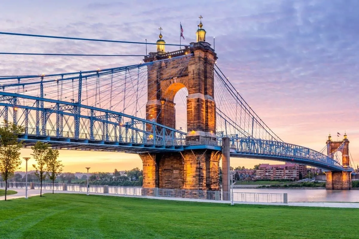 Panoramic sunset view of the Roebling Suspension Bridge and Cincinnati skyline, a popular backdrop for movies filmed in Cincinnati